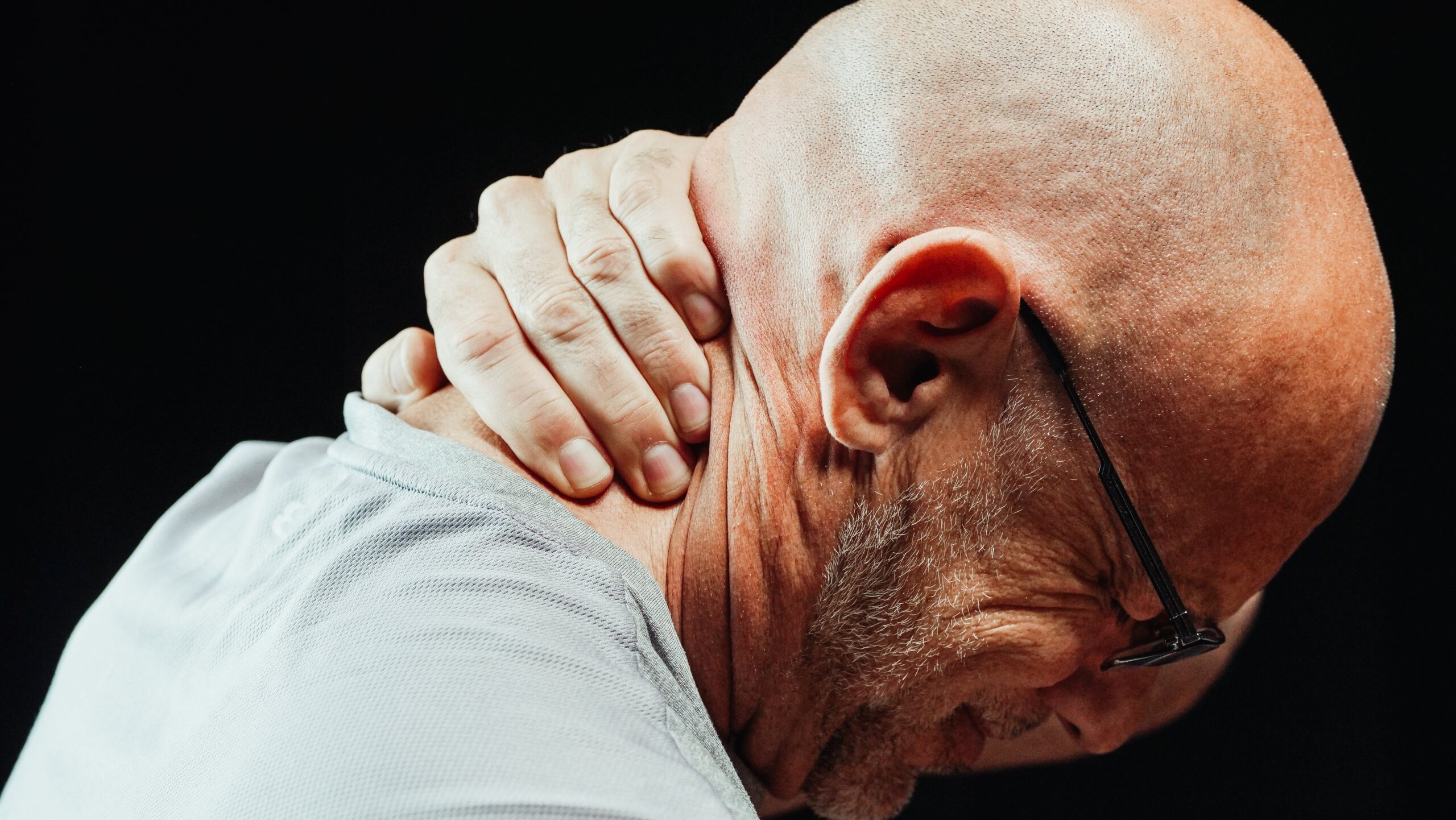 Close-Up Photo of a Man Having a Neck Pain